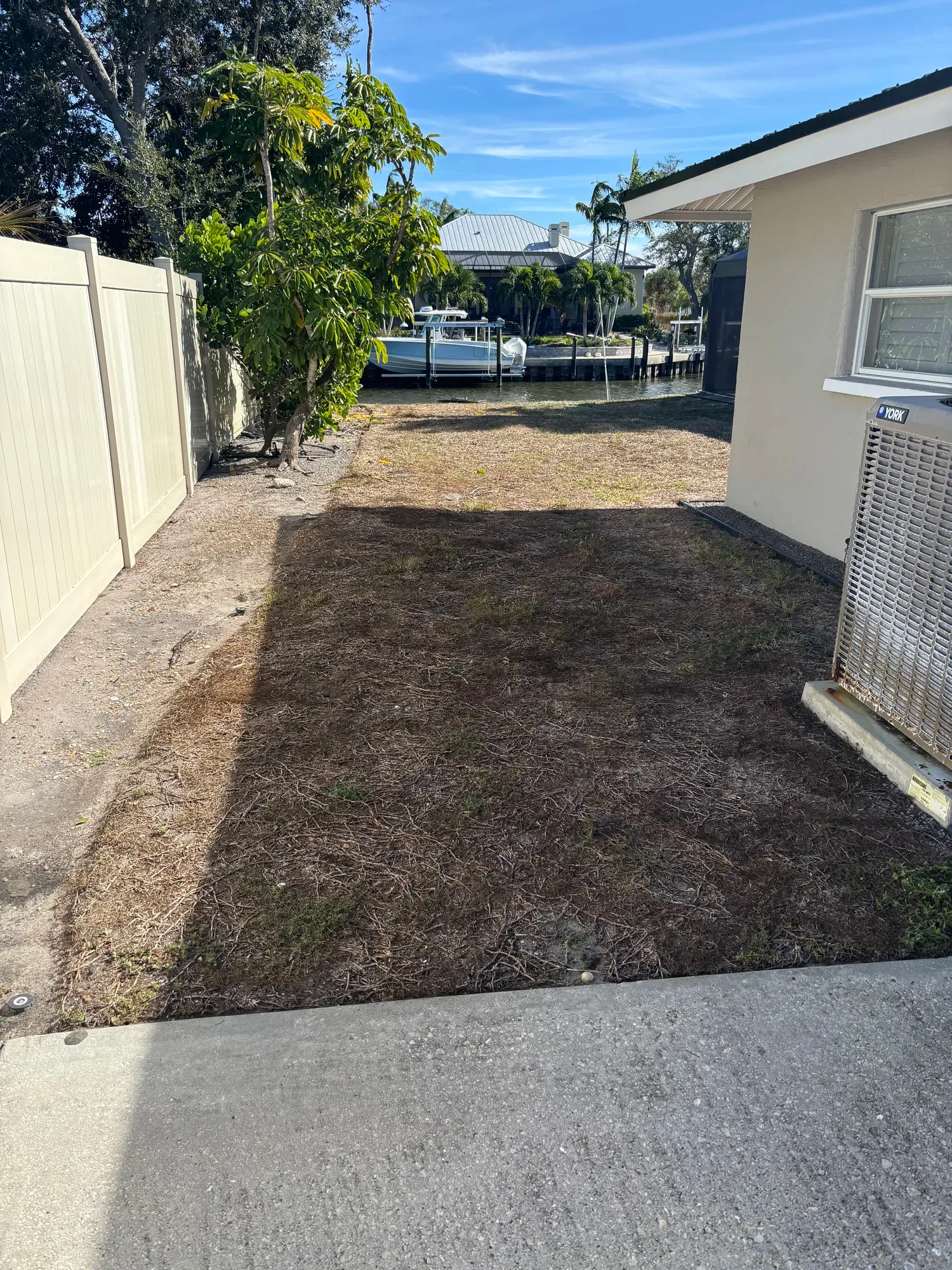 The waterfront yard before artificial turf installation